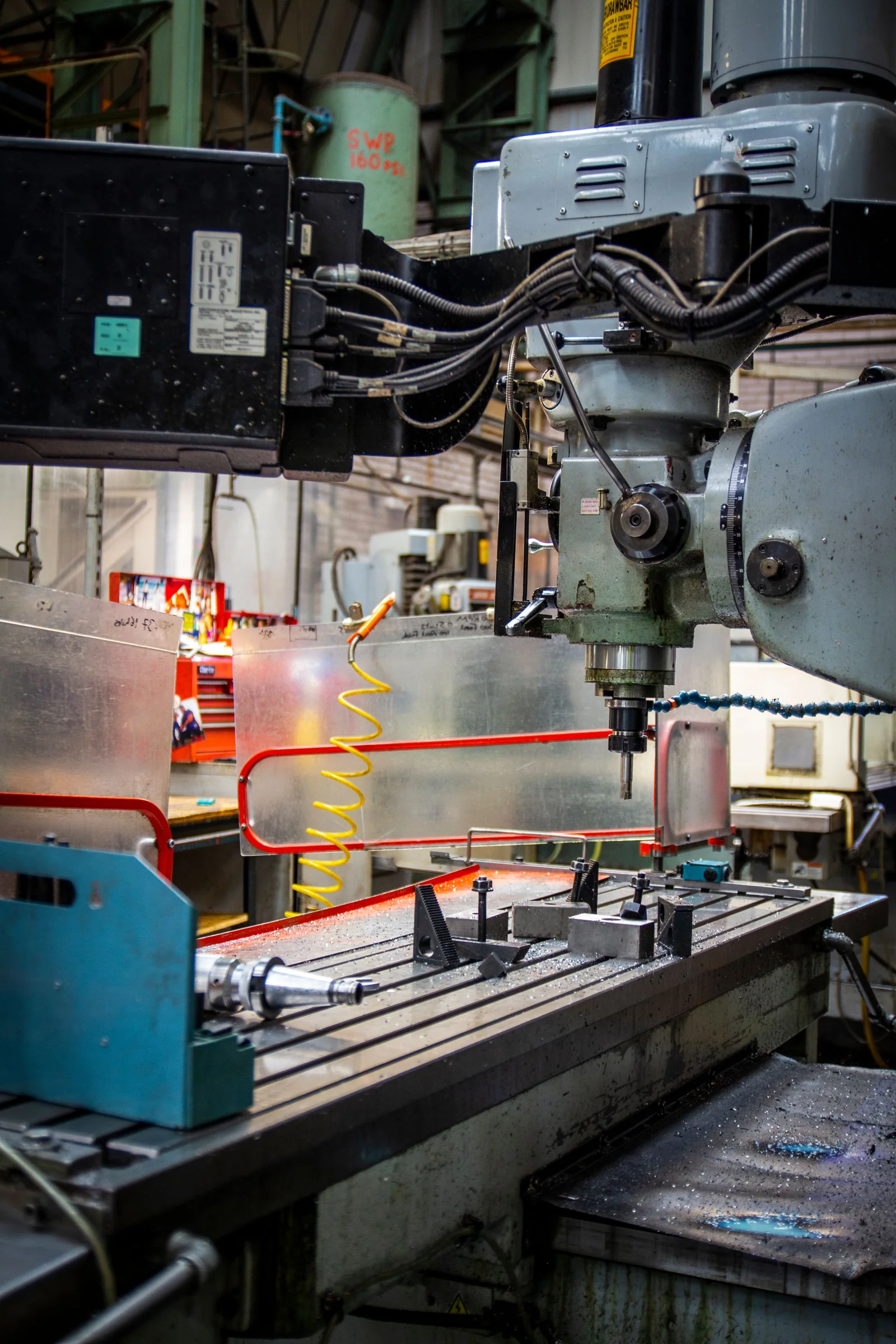 Industrial CNC lathe and tools inside a machine shop