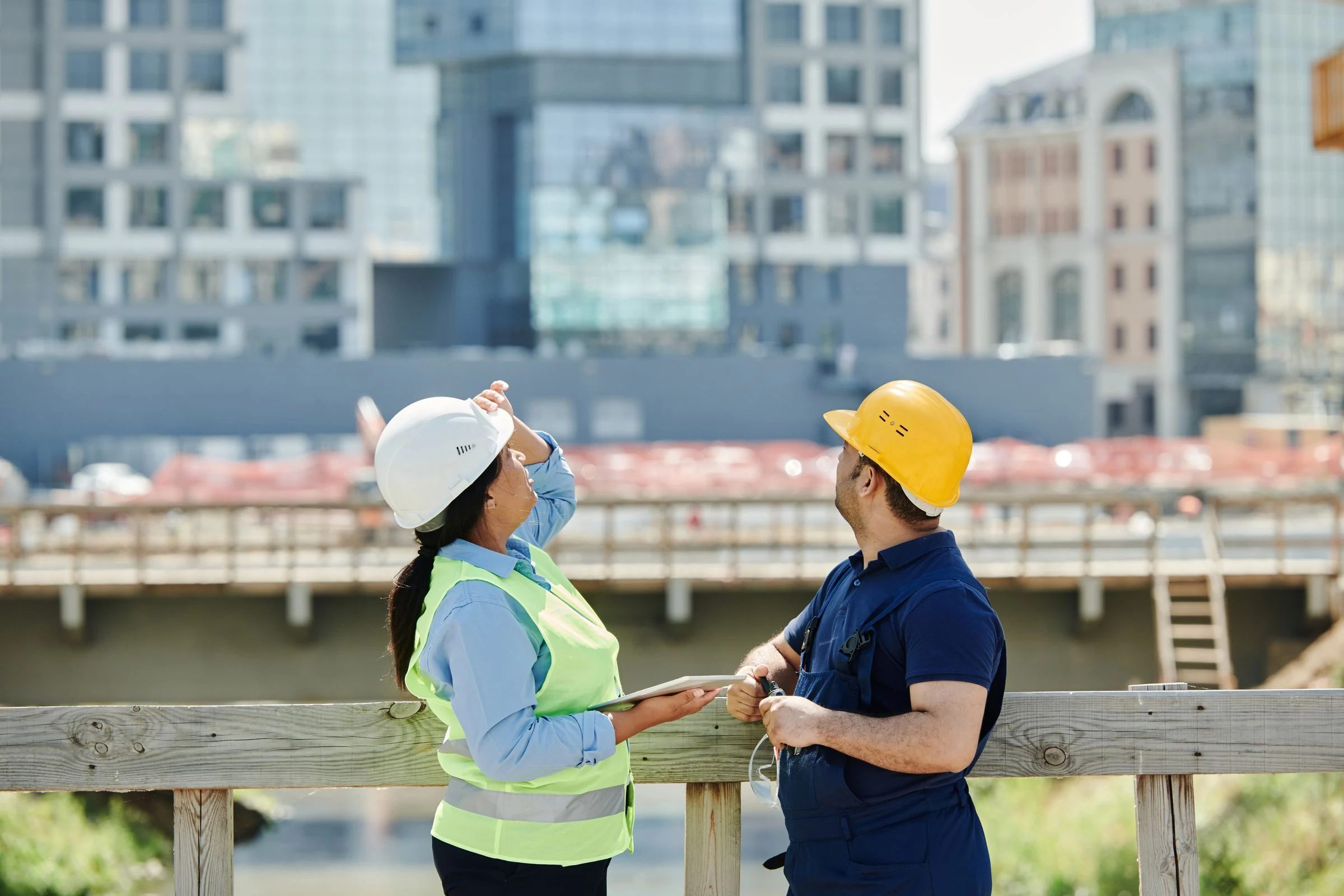 Two engineers discussing plans at a construction site